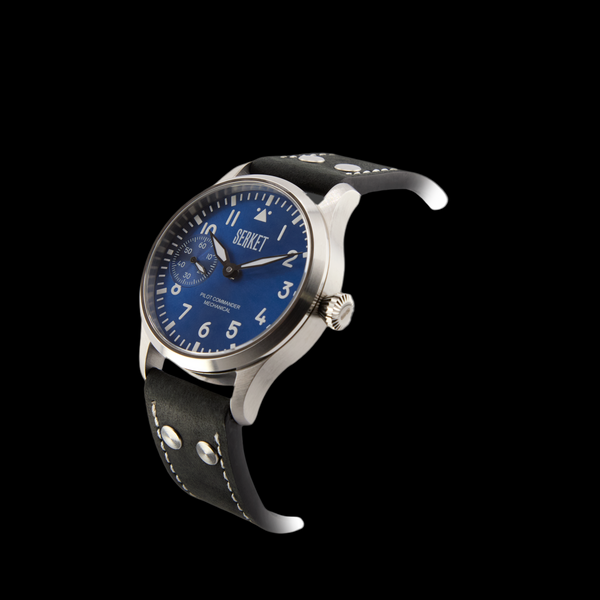 Wristwatch with blue dial and black leather strap on a dark background