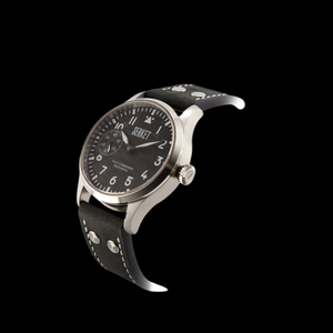 Watch with black strap and silver case on a black background