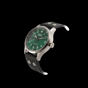 Watch with green dial and black strap on black background