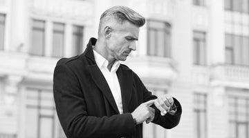 A man looks at his newly fitted watch from Serket Watch Company on the street